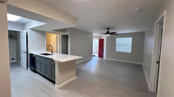 an open kitchen with a sink and stove