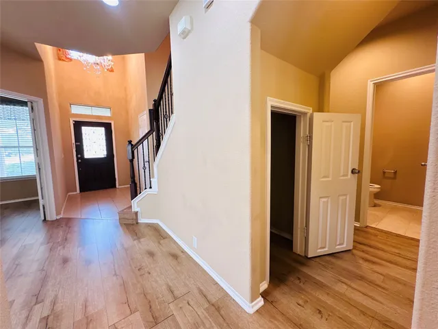 a view of a hallway view with wooden floor and staircase