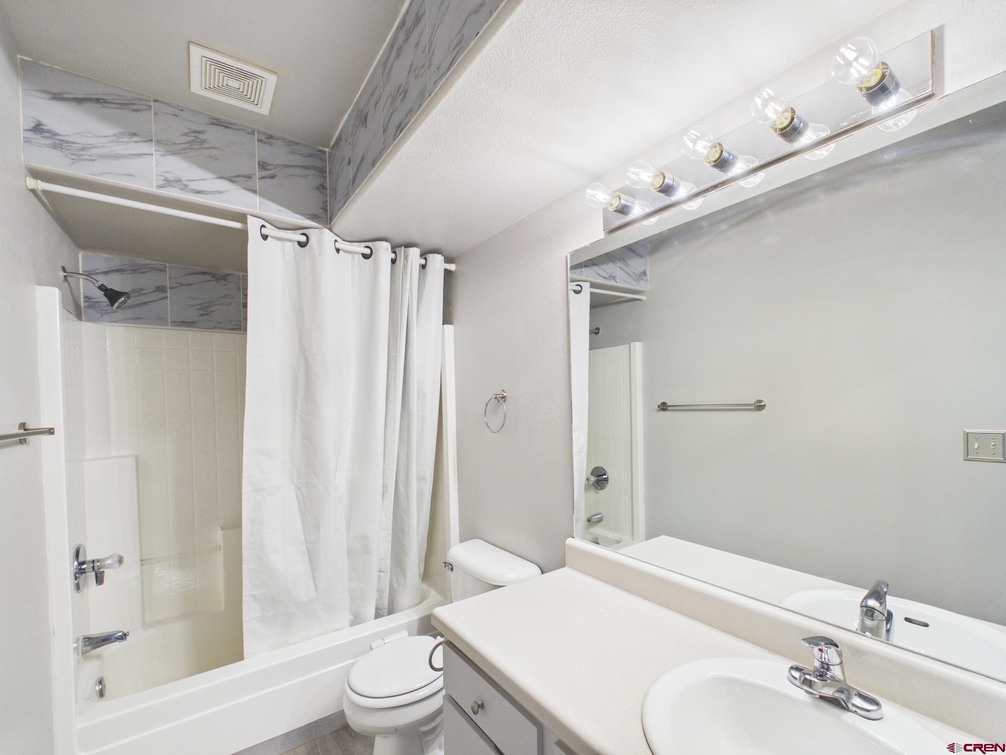 1100 Goeglein Gulch, Unit 216 Durango, CO 81301 - Photo 13 of 25 a bathroom with a sink a toilet and shower