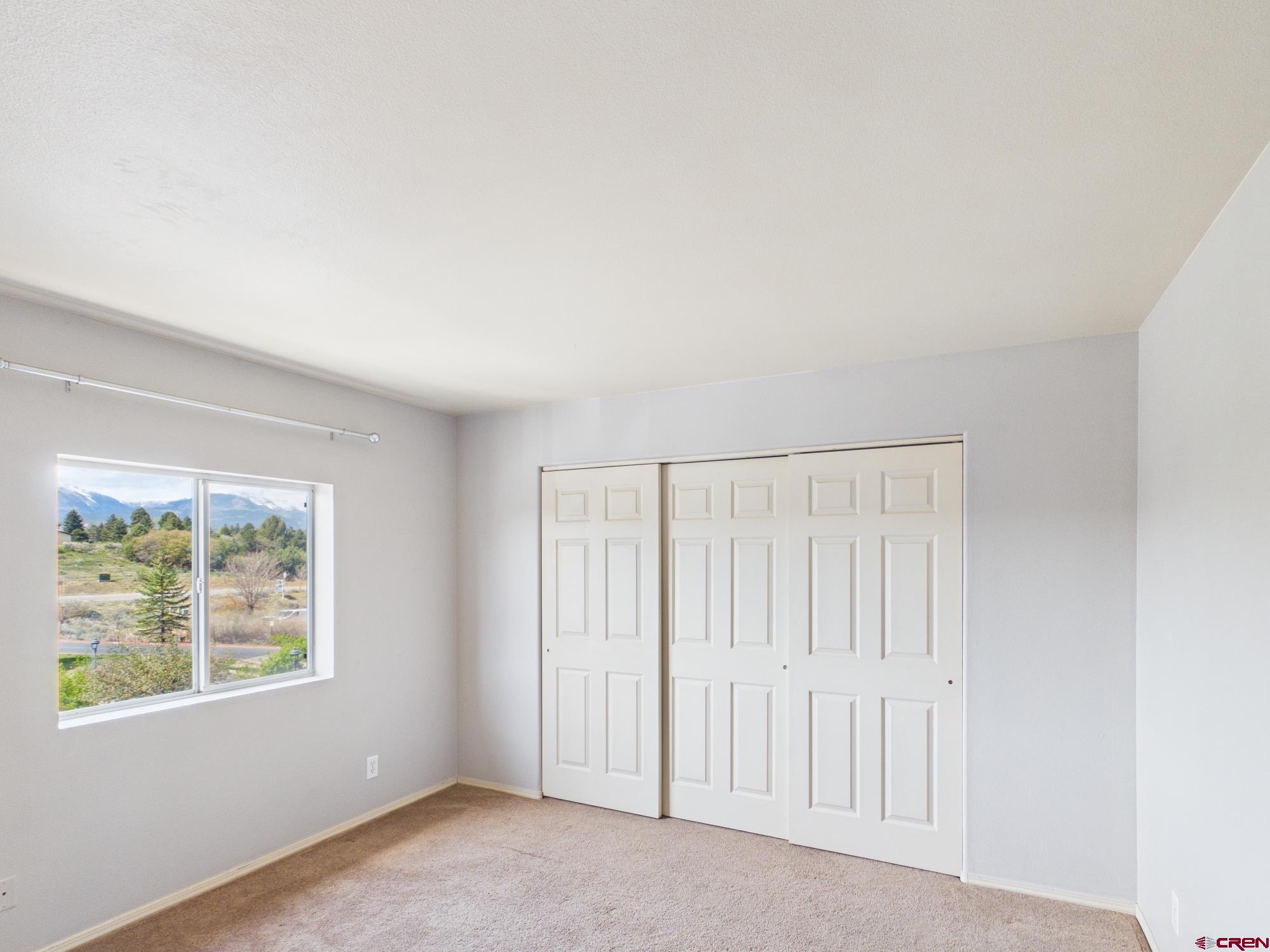 1100 Goeglein Gulch, Unit 216 Durango, CO 81301 - Photo 15 of 25 an empty room with windows