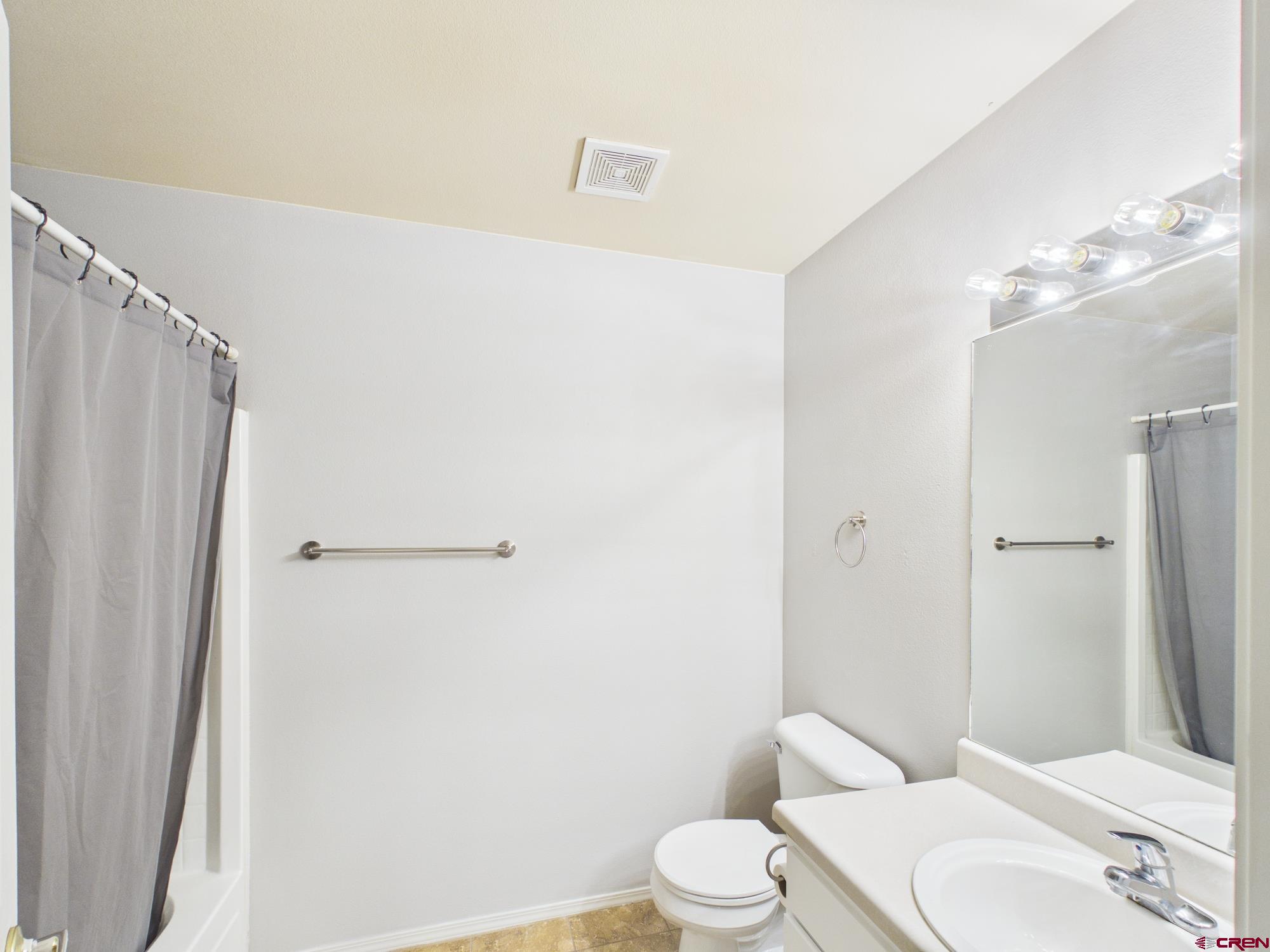 1100 Goeglein Gulch, Unit 216 Durango, CO 81301 - Photo 17 of 25 a white toilet sitting next to a bathroom sink