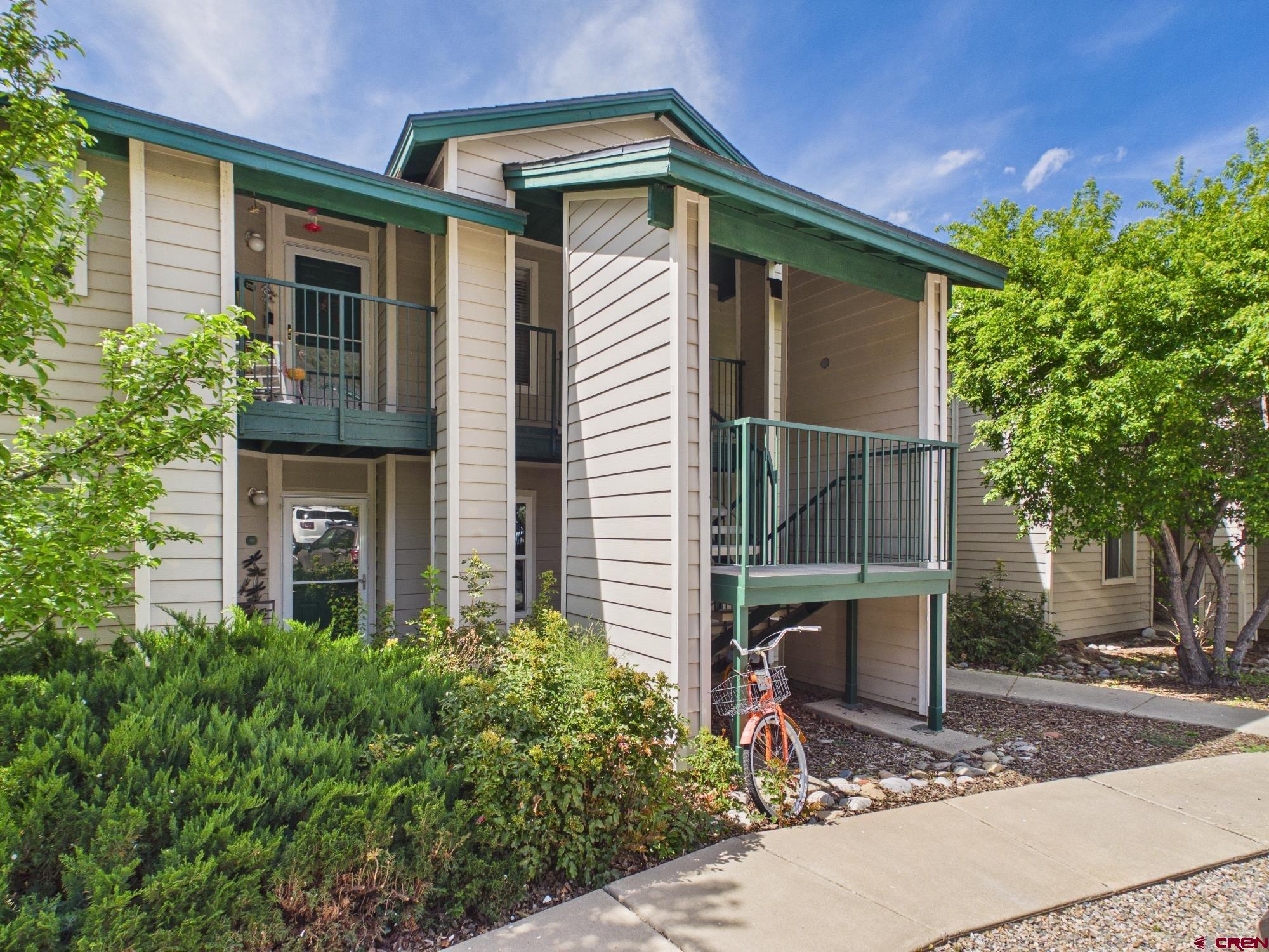 1100 Goeglein Gulch, Unit 216 Durango, CO 81301 - Photo 2 of 25 a front view of a house with garden