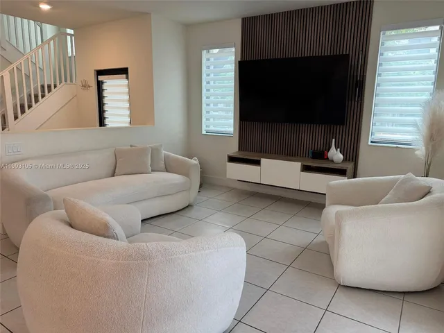 a living room with furniture a rug and a fireplace