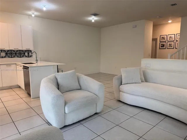 a view of a hallway to rooms and stairs