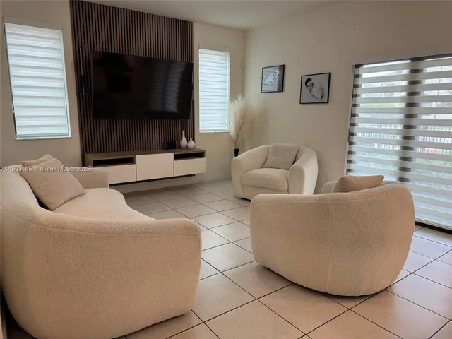 a living room with furniture and a mirror