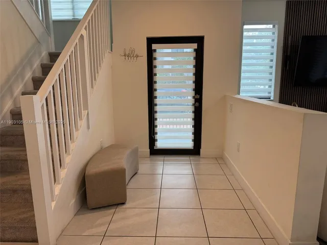 a spacious bathroom with a double vanity sink a mirror and a shower