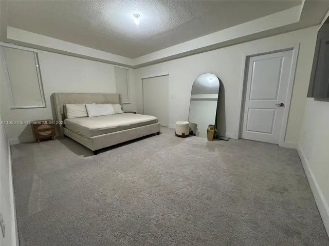 a bedroom with a bed and a chair