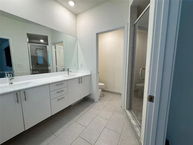 a bathroom with a shower and a sink