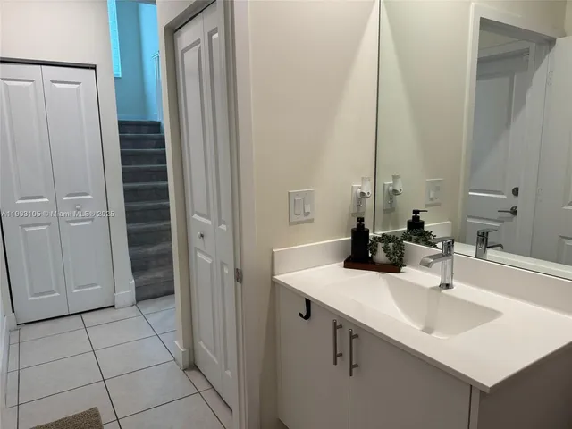 a living room with furniture and floor to ceiling window