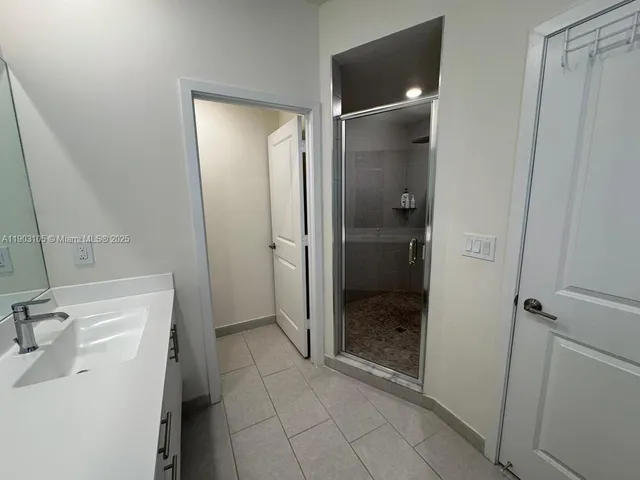 a living room with furniture kitchen view and a window