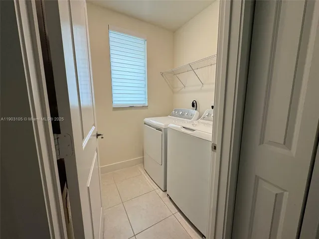 a living room with furniture a rug and a large window