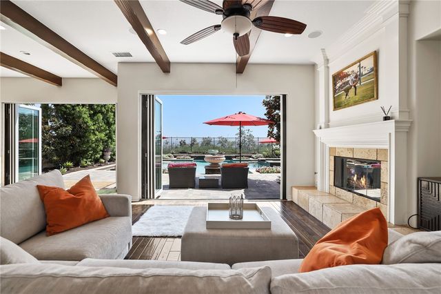 a kitchen with stainless steel appliances granite countertop wooden cabinets a stove top oven a sink and dishwasher with wooden floor