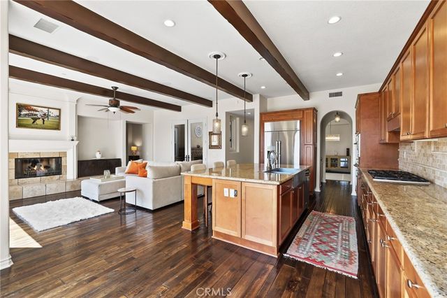 a bedroom with a bed couches chair and a fireplace