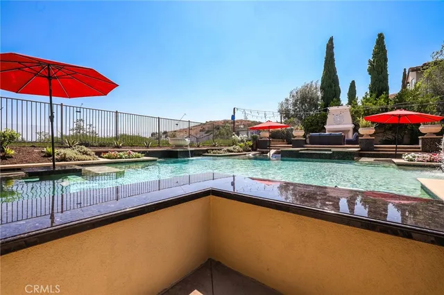 a patio with a table and chairs under an umbrella