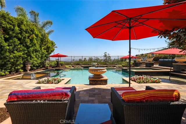 a front view of a house with swimming pool having outdoor seating