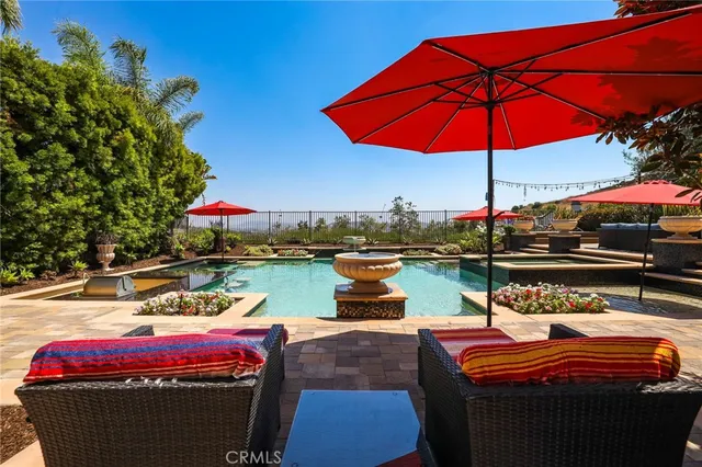 a front view of a house with swimming pool having outdoor seating