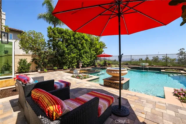 an aerial view of multi story residential apartment building with yard and retail shops