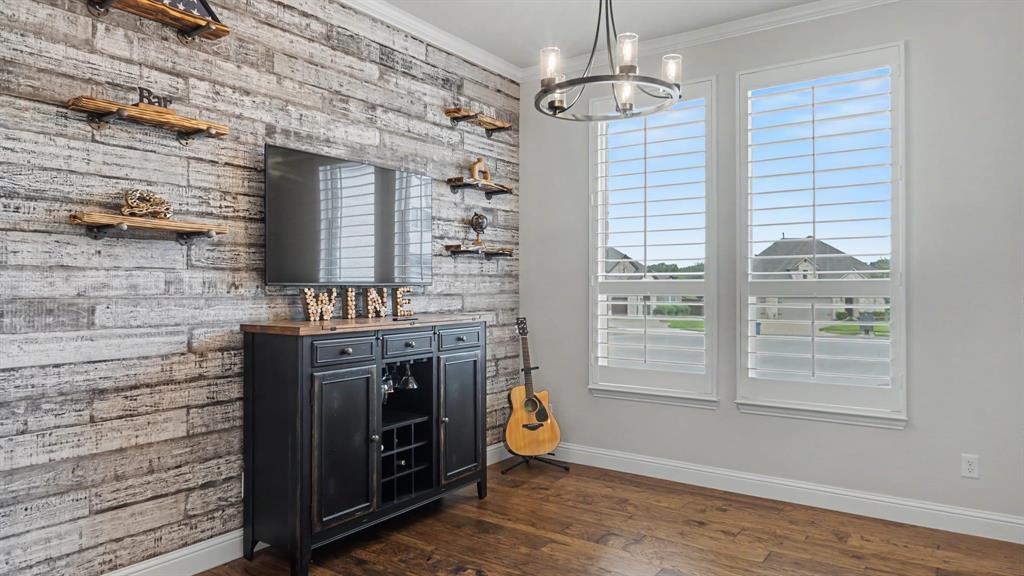 5213 Ravine Ridge Court Flower Mound, TX 76262 - Photo 10 of 40 Formal dining/bar/sitting area with custom shiplap wall and industrial farmhouse style shelves, showcasing hardwood floors and plantation shutters that overlook cul de sac. Could easily be converted to an enclosed room or office.