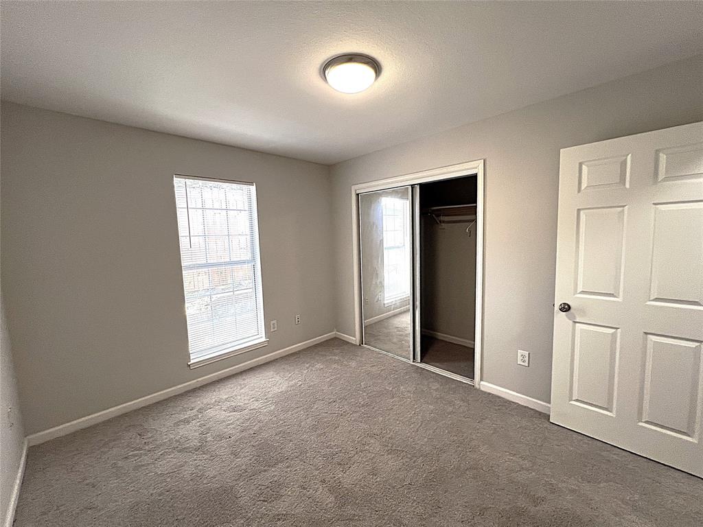 902 Mack Place Denton, TX 76209 - Photo 6 of 11 an empty room with windows and closet