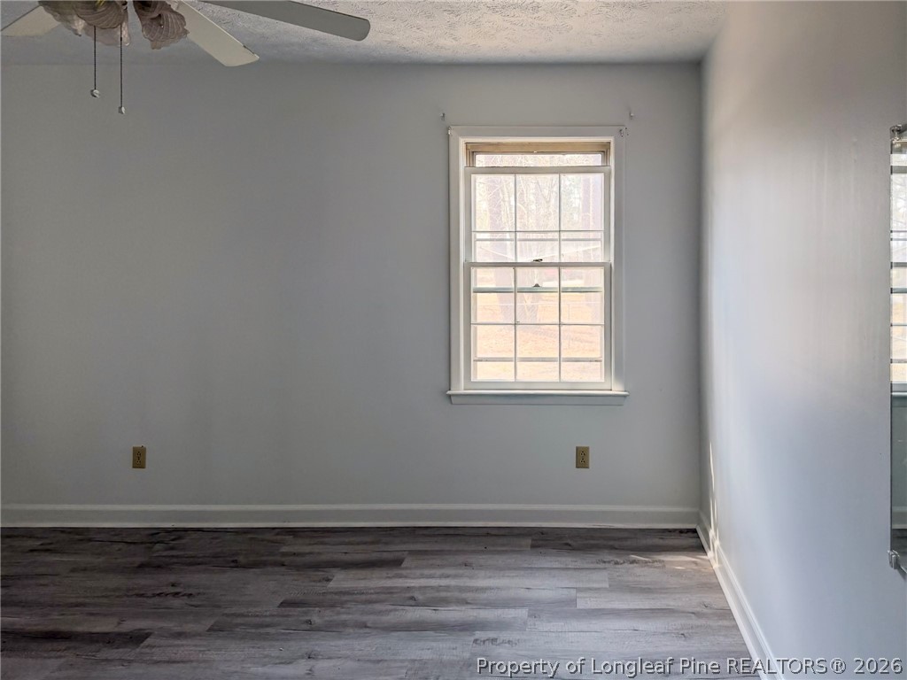 575 Veterans Road St. Pauls, NC 28384 - Photo 13 of 27 a view of an empty room with wooden floor and a window