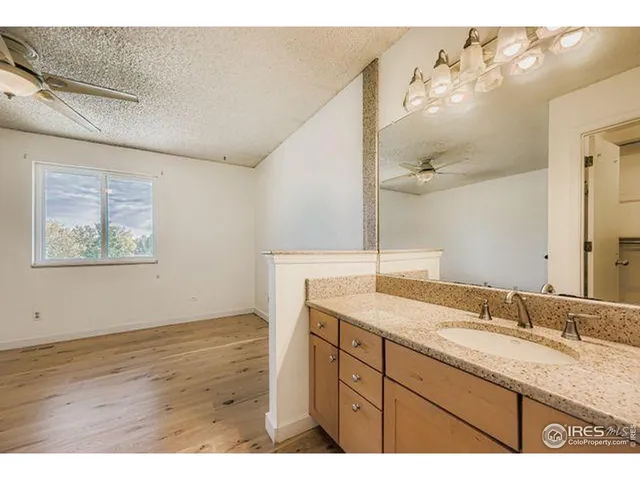 a bathroom with a granite countertop sink mirror and vanity