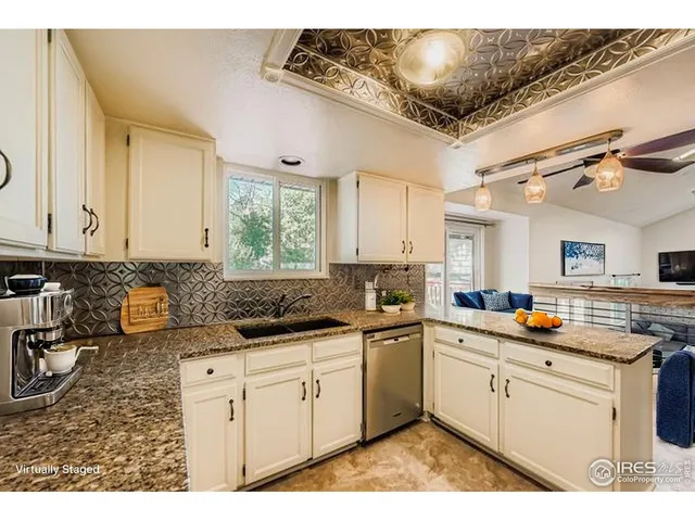 a kitchen with sink a stove and cabinets