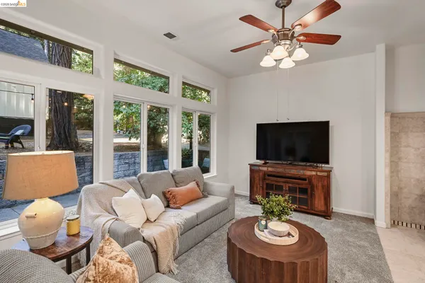 a living room with furniture a fireplace and a flat screen tv