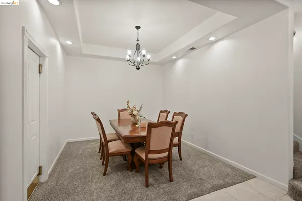 a view of a dining room with furniture and chandelier