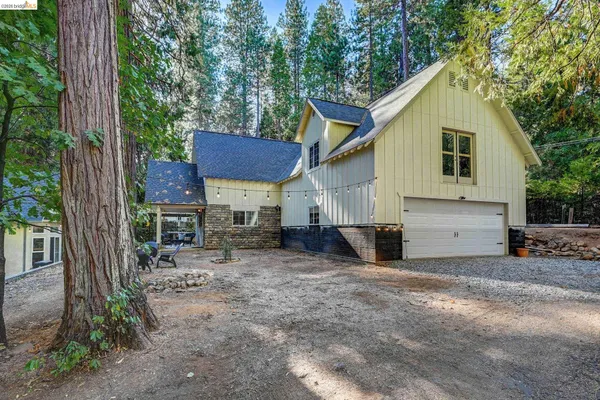 a view of a house with a yard and sitting area