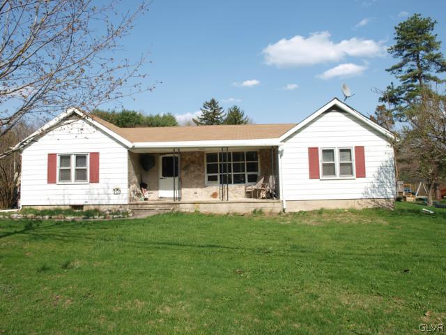 a front view of a house with a garden and porch