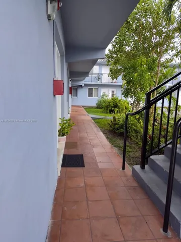 a view of a pathway with a garden