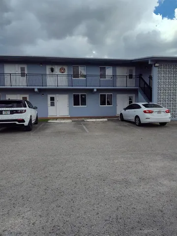 a view of parking area and car parked in garage