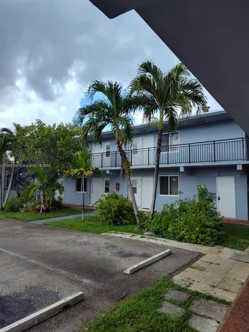 a palm tree in front of a house