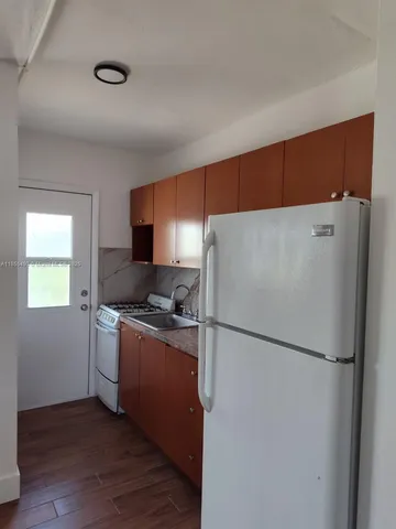 a kitchen with a refrigerator sink and stove