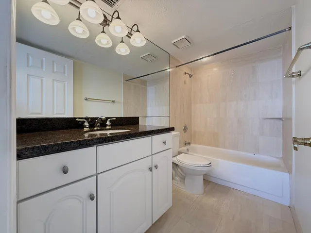 a bathroom with a sink a toilet and a shower