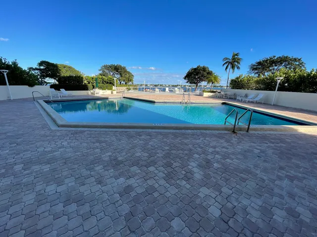 a view of swimming pool with buildings in background