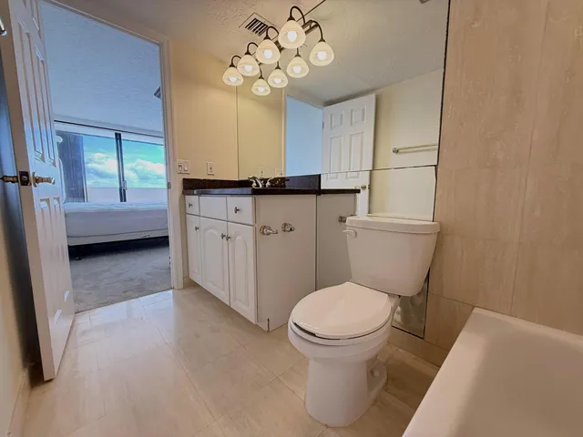 a bathroom with a toilet sink and shower