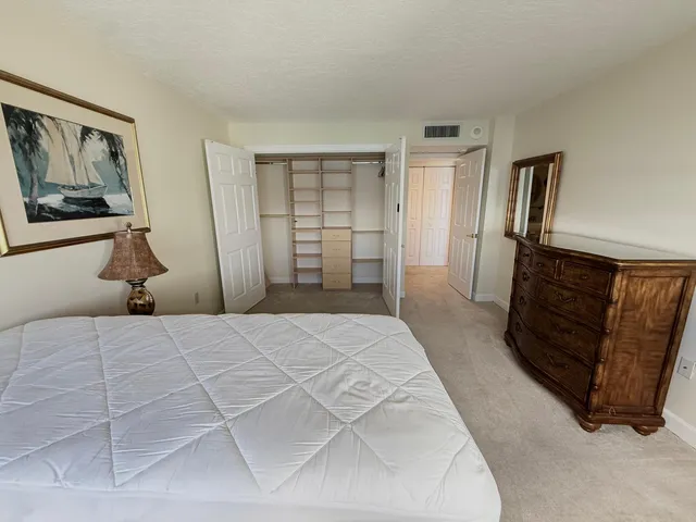 a bedroom with a bed and walk in closet