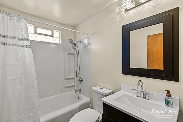 a bathroom with a sink toilet tub and shower
