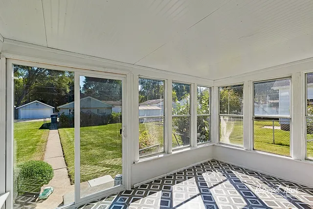 a view of a balcony with chair and floor to ceiling windows