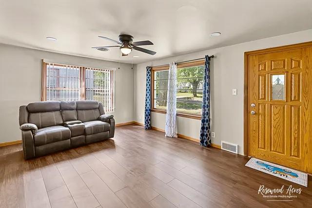 a living room with furniture and wooden floor