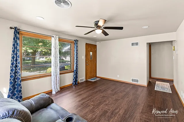 a living room with hardwood floor and a window