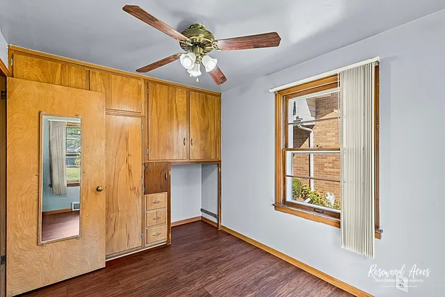 a view of an entryway with wooden floor and cabinet