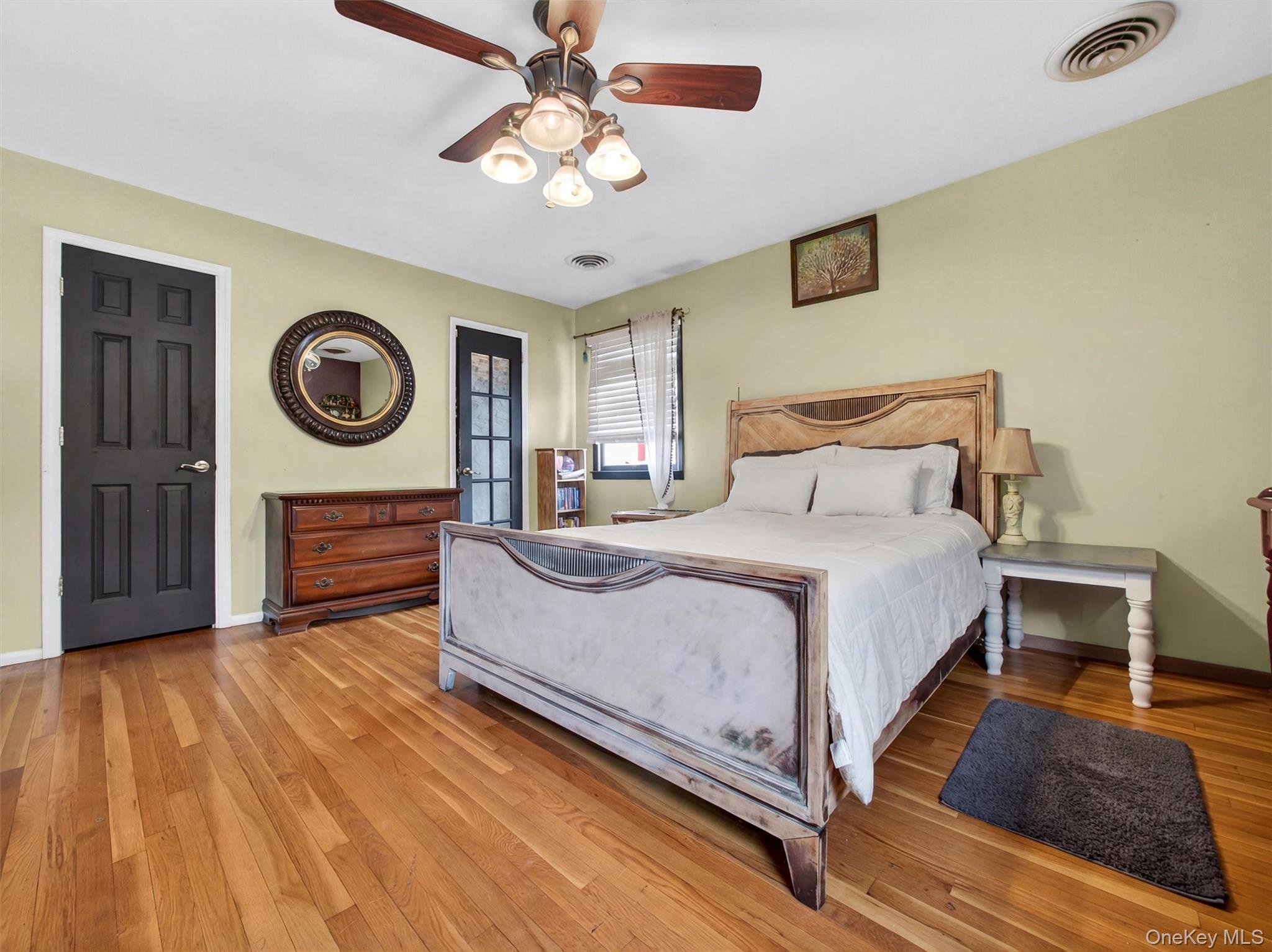 54 Blauvelt Road Blauvelt, NY 10913 - Photo 25 of 41 a bedroom with a bed mirror and a chandelier