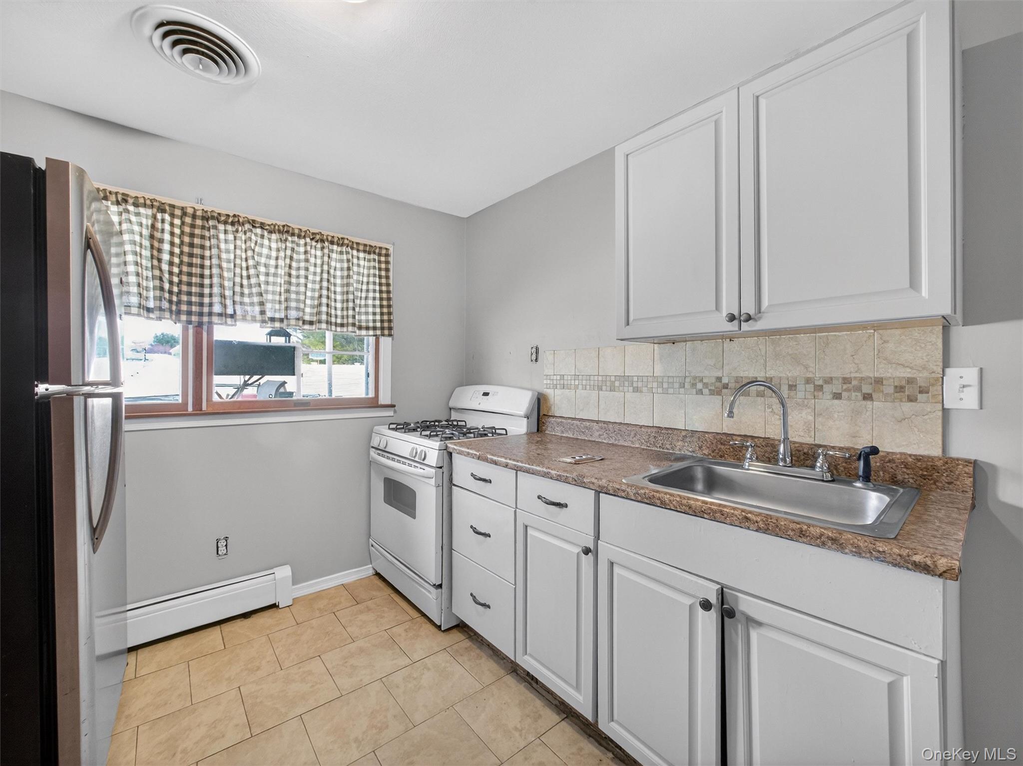 54 Blauvelt Road Blauvelt, NY 10913 - Photo 32 of 41 a kitchen with a sink stove and cabinets