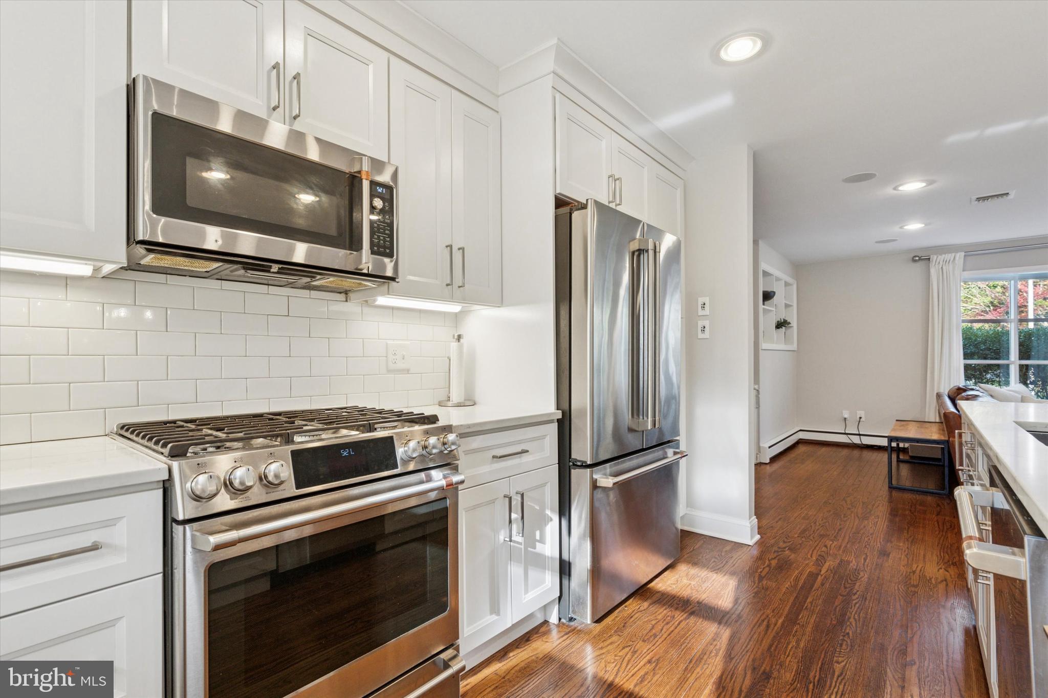 913 Penn Valley Road Media, PA 19063 - Photo 13 of 34 a kitchen with stainless steel appliances a stove a microwave and a refrigerator