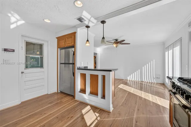 a view of hallway with stairs and wooden floor