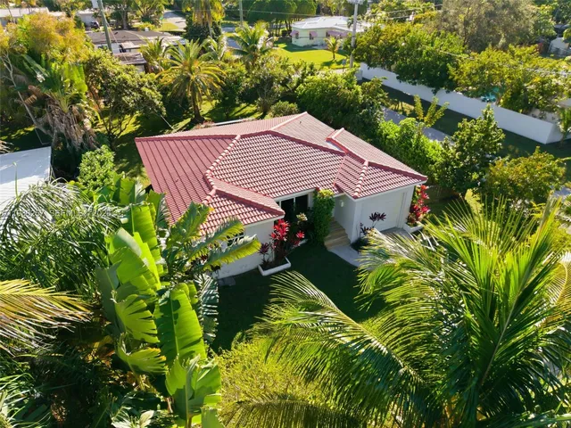 a aerial view of a house with swimming pool and garden