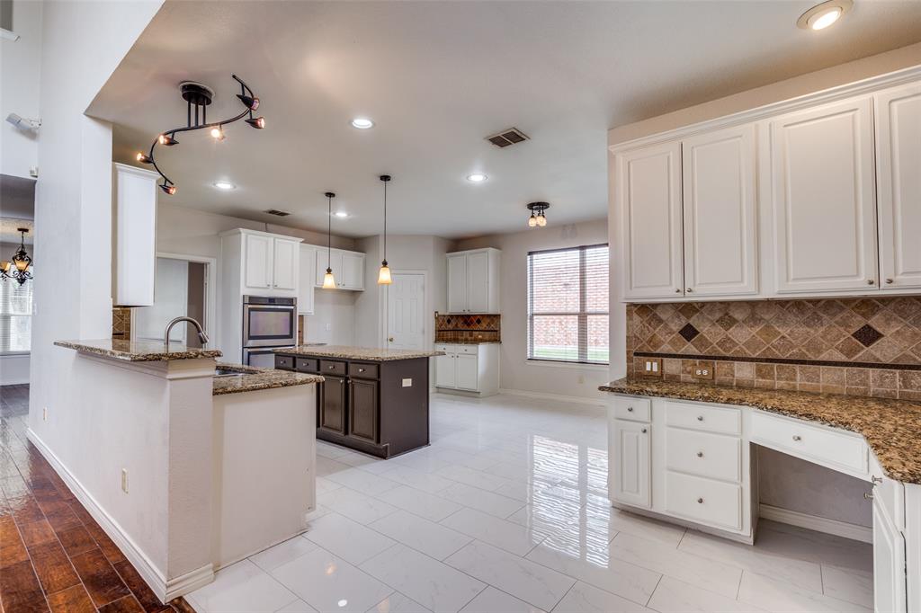 3421 Neiman Road Plano, TX 75025 - Photo 14 of 40 Kitchen featuring stone countertops, backsplash, white cabinetry, and recessed lighting