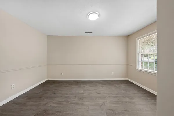 a view of a room with wooden floor